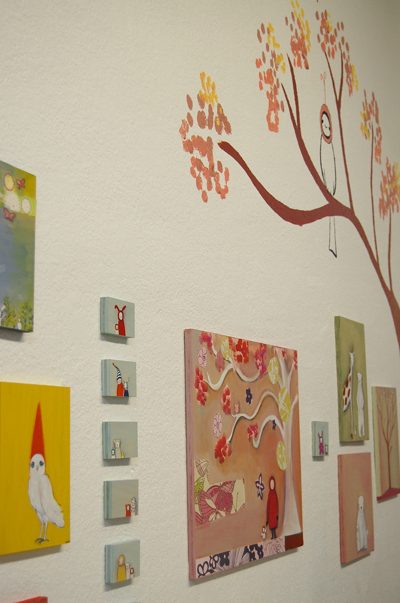 the paintings are hung in the gallery with care